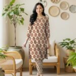 Model posing in a matching 2-piece pale ochre lawn co-ord set with Sunehri Peela (Mustard Gold) floral block print motifs.