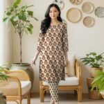 Model posing in a matching 2-piece neutral beige lawn co-ord set with Ghaara Surkh (Deep Maroon Red) floral block print motifs.
