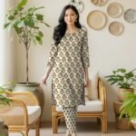 Model posing in a matching 2-piece light terracotta lawn co-ord set with Gajri ya Orange (Muted Rust/Orange) floral block print motifs.