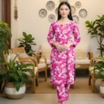 Model posing in a matching 2-piece vibrant shocking pink lawn twin set with white and orange vivid pulse daisy ring prints.