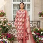 Model posing outdoors in a matching 3-piece dusty rose and burgundy garden bloom premium lawn suit with a printed matching dupatta.