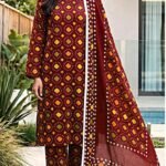 Model posing in a matching 3-piece deep maroon indus dot traditional bandhani lawn suit with a matching dupatta.